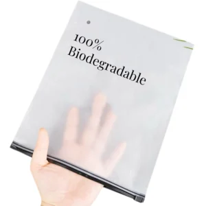 Frosted biodegradable bag held by hand, showing eco-friendly material and custom printing option