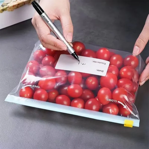 Food storage bag with writable label area being marked while holding fresh tomatoes