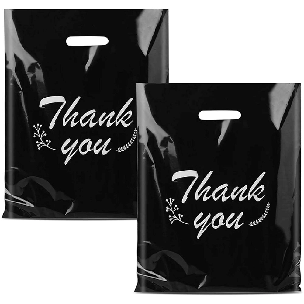Black plastic shopping bags with die-cut handles and white thank you text for retail packaging